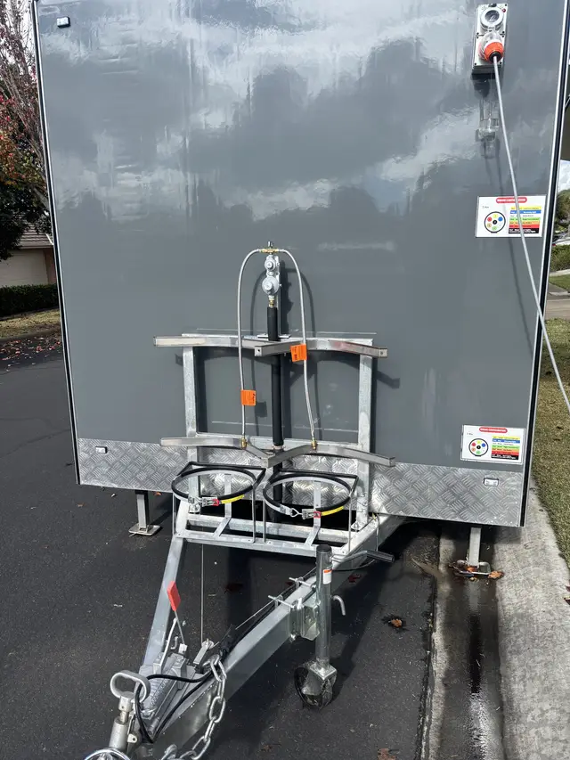 Twin LPG cylinder bracket with regulator and gas hoses fitted to the front of a trailer